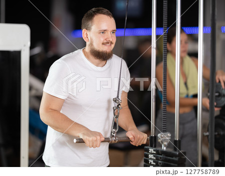 Man doing arm training Man doing arm training 127758789