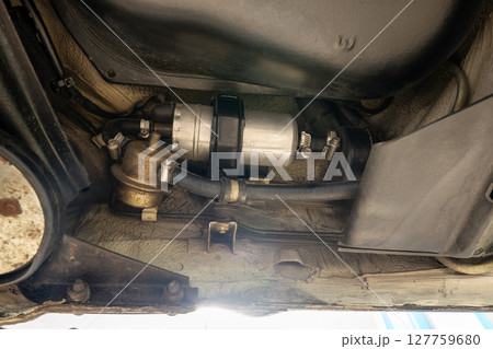 Here is a detailed view showcasing a fuel pump setup that has been expertly installed beneath a vehicles chassis 127759680