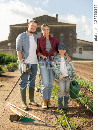 Family of farmers standing in the garden 127760346