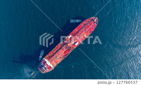 Aerial view oil ship tanker vessel loading and unloading in oil terminal station refinery, Global business import export logistic transport sea freight cargo tanker, Red crude oil tanker ship at port. Aerial view oil ship tanker vessel loading and unloading in oil terminal station refinery, Global business import export logistic transport sea freight cargo tanker, Red crude oil tanker ship at port. 127760537