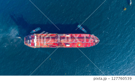Aerial view oil ship tanker vessel loading and unloading in oil terminal station refinery, Global business import export logistic transport sea freight cargo tanker, Red crude oil tanker ship at port. 127760539
