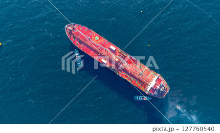 Aerial view oil ship tanker vessel loading and unloading in oil terminal station refinery, Global business import export logistic transport sea freight cargo tanker, Red crude oil tanker ship at port. 127760540