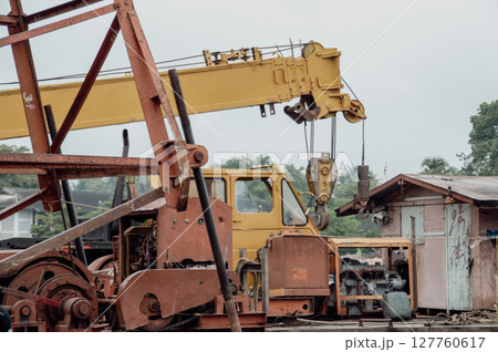 A close-up view of heavy machinery at a construction site, showcasing the power and complexity of industrial equipment. 127760617