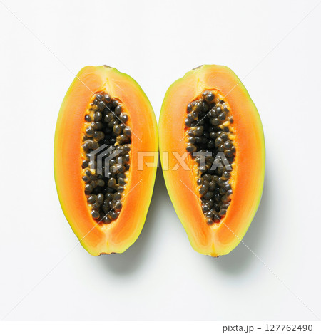 two half cut of ripe papaya with seeds isolated on white background 127762490