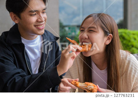 Young Asian couple eating fried chicken 127763231
