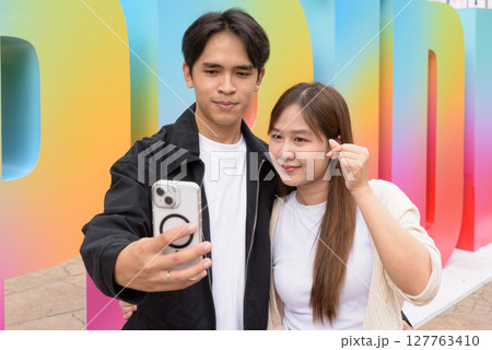 LGTBQ Pride supporting couple selfie portrait 127763410