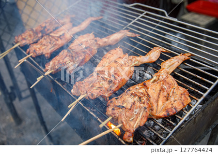 Grilled Chicken on Skewers over Hot Charcoal, Smoking Barbecue Preparation 127764424