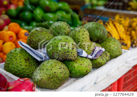 Soursop Guyabano Guanabana Graviola Exotic Green Fruit at Tropical Asian Market with Bananas and Oranges Soursop Guyabano Guanabana Graviola Exotic Green Fruit at Tropical Asian Market with Bananas and Oranges 127764429