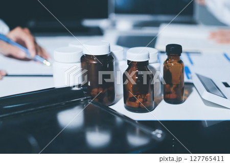 Male and female doctors are having a meeting in a hospital room. Male and female doctors are having a meeting in a hospital room. 127765411