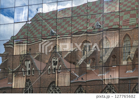 Colorful Church Facade Reflection in Glass Building Panels Colorful Church Facade Reflection in Glass Building Panels 127765682