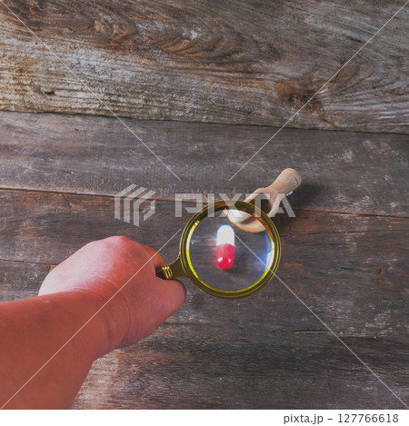 Magnifying glass with pharmaceutical medicine pills, Magnifying glass with pharmaceutical medicine pills, 127766618