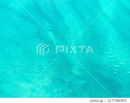 A stunning view of the blue expanse of sea water in Calabria, Italy, where the deep turquoise and sapphire tones of the Tyrrhenian Sea stretch to the horizon. The sunlight dances on the gentle waves A stunning view of the blue expanse of sea water in Calabria, Italy, where the deep turquoise and sapphire tones of the Tyrrhenian Sea stretch to the horizon. The sunlight dances on the gentle waves 127766905