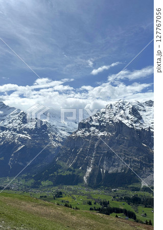 Swiss of towering mountains valleys under bright sky creates serene picturesque Switzerland landscape hiking destination. Swiss of towering mountains valleys under bright sky creates serene picturesque Switzerland landscape hiking destination. 127767056