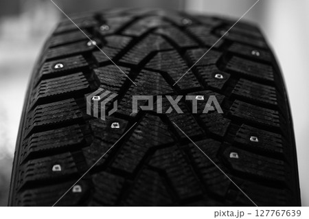 A detailed close-up shot of a winter tire showcasing its intricate tread pattern 127767639