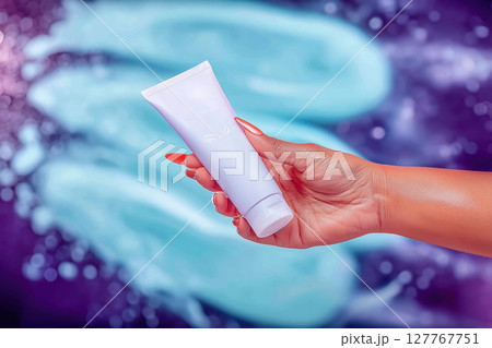 Female hand holding white tube. colorful background 127767751
