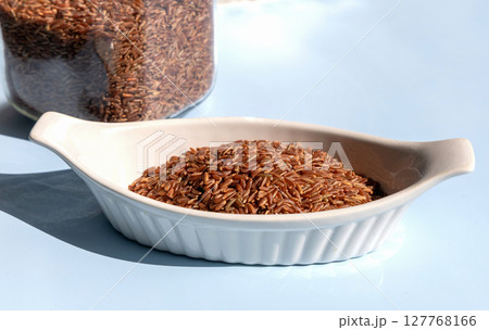 Healthy uncooked raw or brown red rice 127768166