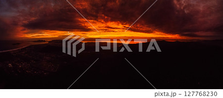 Panorama of sunrise or sunset with clouds and silhouette of coastline in Brazil Panorama of sunrise or sunset with clouds and silhouette of coastline in Brazil 127768230