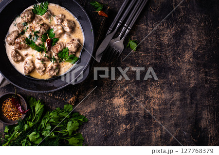 Meatballs in sour cream sauce in a frying pan Meatballs in sour cream sauce in a frying pan 127768379