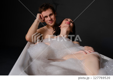 Couple sharing a moment together in bed while taking a selfie Couple sharing a moment together in bed while taking a selfie 127769520