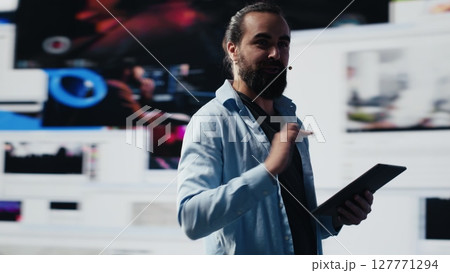 Male live presenter communicating to an audience about branding strategy and social trends, using microphone during presentation to help with communication and global reach. Camera A. 127771294
