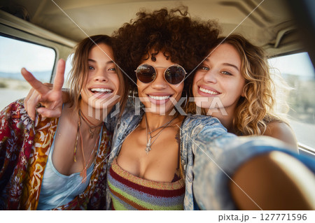 Three women are smiling and posing for a picture in a van 127771596