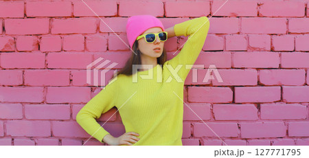 Portrait stylish young teenager girl in vivid colorful clothes, knitted yellow sweater and pink hat 127771795