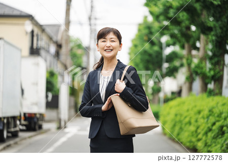 スーツを着たミドル女性の屋外ポートレート スーツを着たミドル女性の屋外ポートレート 127772578