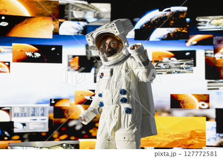 Space man on a deep space mission surrounded by stars and the vast galaxy, showcasing science and exploration. Astronaut with helmet travelling in the universe within, human curiosity. 127772581