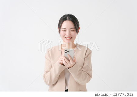 スマホを持つスーツの女性 127773012