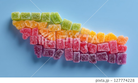 Rainbow Colored Sugar Candy on Blue Background 127774228