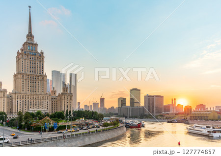 High-rise stalinist building near river at summer sunset in Moscow, Russia. Historic name is Hotel Ukraine. 127774857