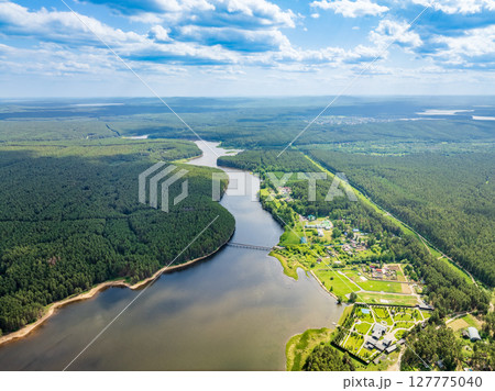 Aerial view of lake or river green shore with forest. Summer season. Aerial view of lake or river green shore with forest. Summer season. 127775040