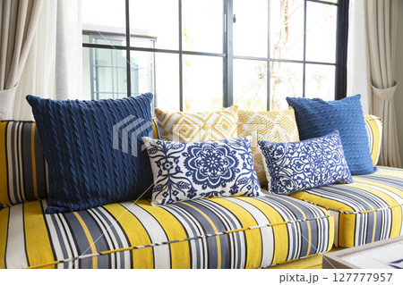 Mediterranean living room interior with bright yellow and blue sofa and pillow. Modern decor living room with carpet. Mediterranean living room interior with bright yellow and blue sofa and pillow. Modern decor living room with carpet. 127777957