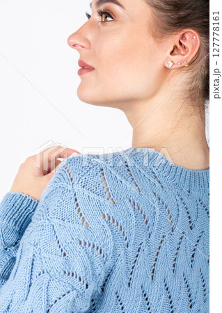 Beautiful woman studio portrait wearing blue sweater 127778161
