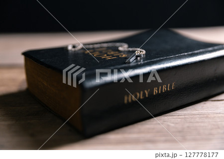 Religious belief concept Close up prayer Christian church service Bible Holy cross Spiritual power Blurred background Desk copy space Heaven God Catholic faith Praise book Jesus worship Gospel symbols 127778177
