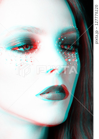 Beautiful woman portrait with glued jewelry on her face in RGB color split effect style 127778220
