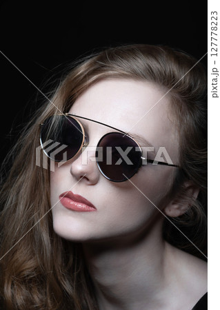 Beautiful woman with sunglasses close-up studio portrait Beautiful woman with sunglasses close-up studio portrait 127778223