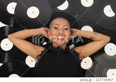 Thai beautiful woman lying on vinyl records Thai beautiful woman lying on vinyl records 127778467