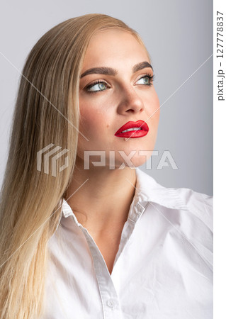 Beautiful blonde woman with long hair and red lipstick close-up studio portrait Beautiful blonde woman with long hair and red lipstick close-up studio portrait 127778837