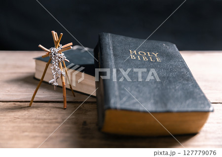 Religious belief concept Close up prayer Christian church service Bible Holy cross Spiritual power Blurred background Desk copy space Heaven God Catholic faith Praise book Jesus worship Gospel symbols 127779076