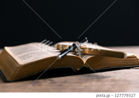 Religious belief concept Close up prayer Christian church service Bible Holy cross Spiritual power Blurred background Desk copy space Heaven God Catholic faith Praise book Jesus worship Gospel symbols 127779327