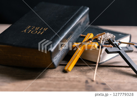 Religious belief concept Close up prayer Christian church service Bible Holy cross Spiritual power Blurred background Desk copy space Heaven God Catholic faith Praise book Jesus worship Gospel symbols 127779328