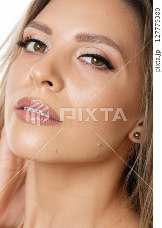 Close-up studio portrait of sexy blonde woman with natural make-up Close-up studio portrait of sexy blonde woman with natural make-up 127779380