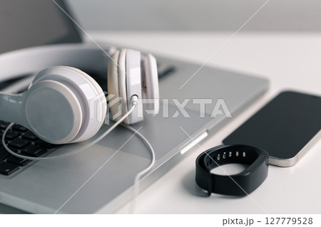 New technology modern Close up high resolution Wireless Earphones white Earbuds headphones black blur background Trendy minimal music device laptop concept phone accessories Comfortable Wooden table 127779528