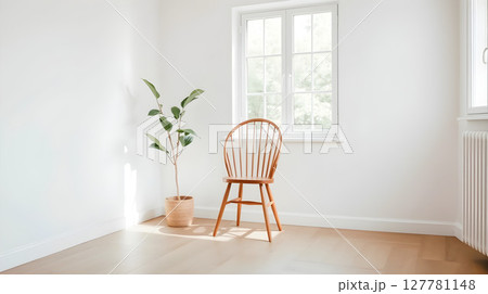 Minimalist interior design with a wooden chair, potted plant, and window creating a serene space. Minimalist interior design with a wooden chair, potted plant, and window creating a serene space. 127781148
