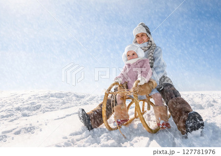 Children sled down the hill 127781976