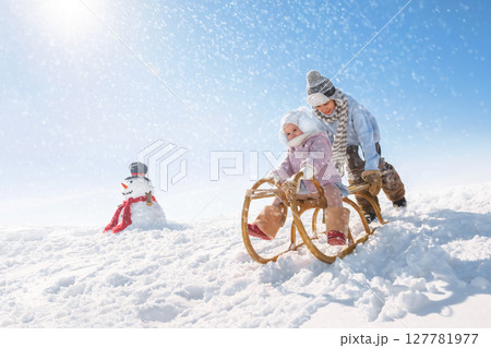 Children sled down the hill 127781977