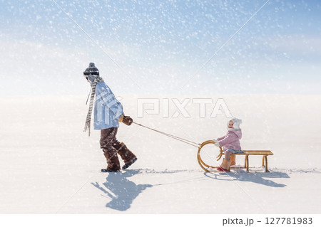 Children sled down the hill Children sled down the hill 127781983
