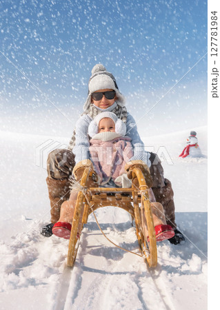 Children sled down the hill 127781984