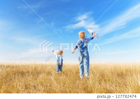 Little boys running in the open air. 127782474